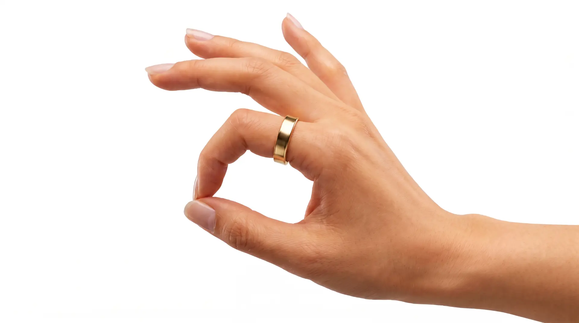 Hand wearing a polished gold ring against a light background
